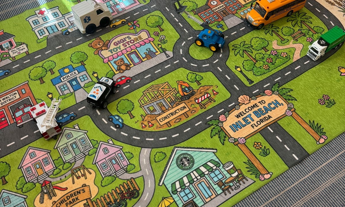 Toy trucks parked on a custom Inlet Beach play mat